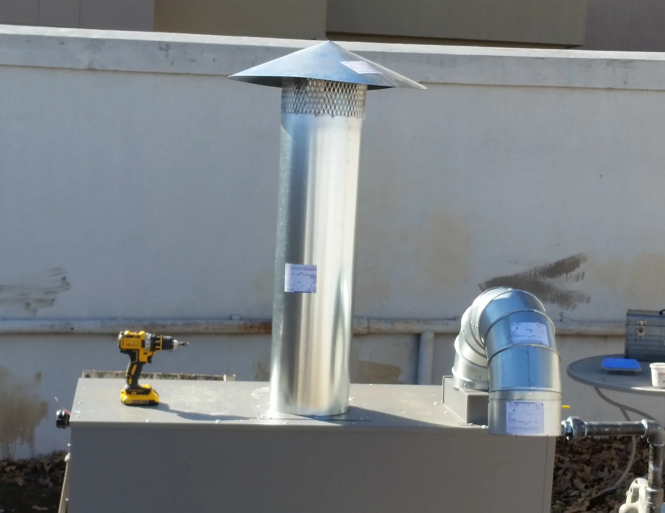 Flue/vent connection detail and outdoor boiler installation at Crowne Plaza