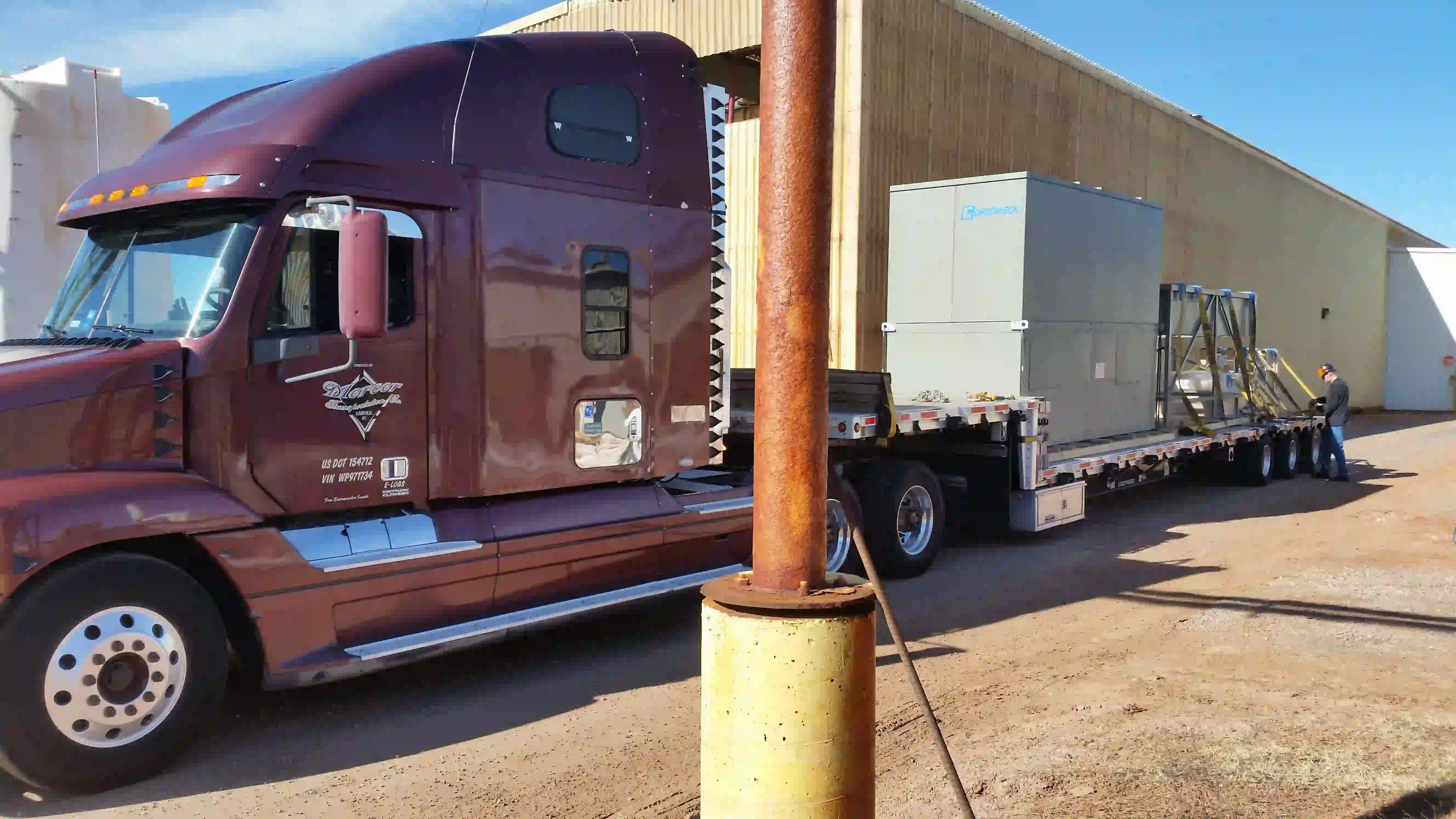 Flatbed truck delivery of the new makeup air heater at the National Standard facility