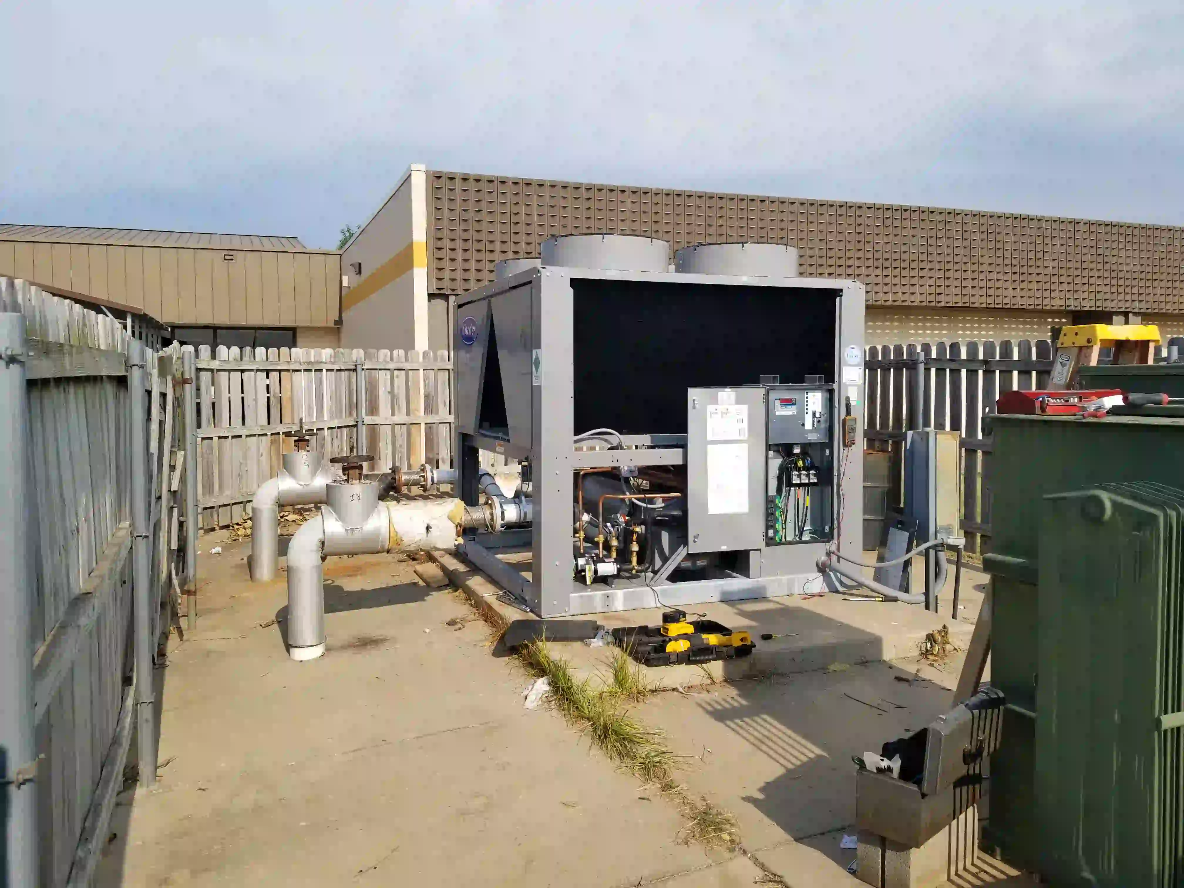 Chiller controls and electrical panel open during commissioning and startup