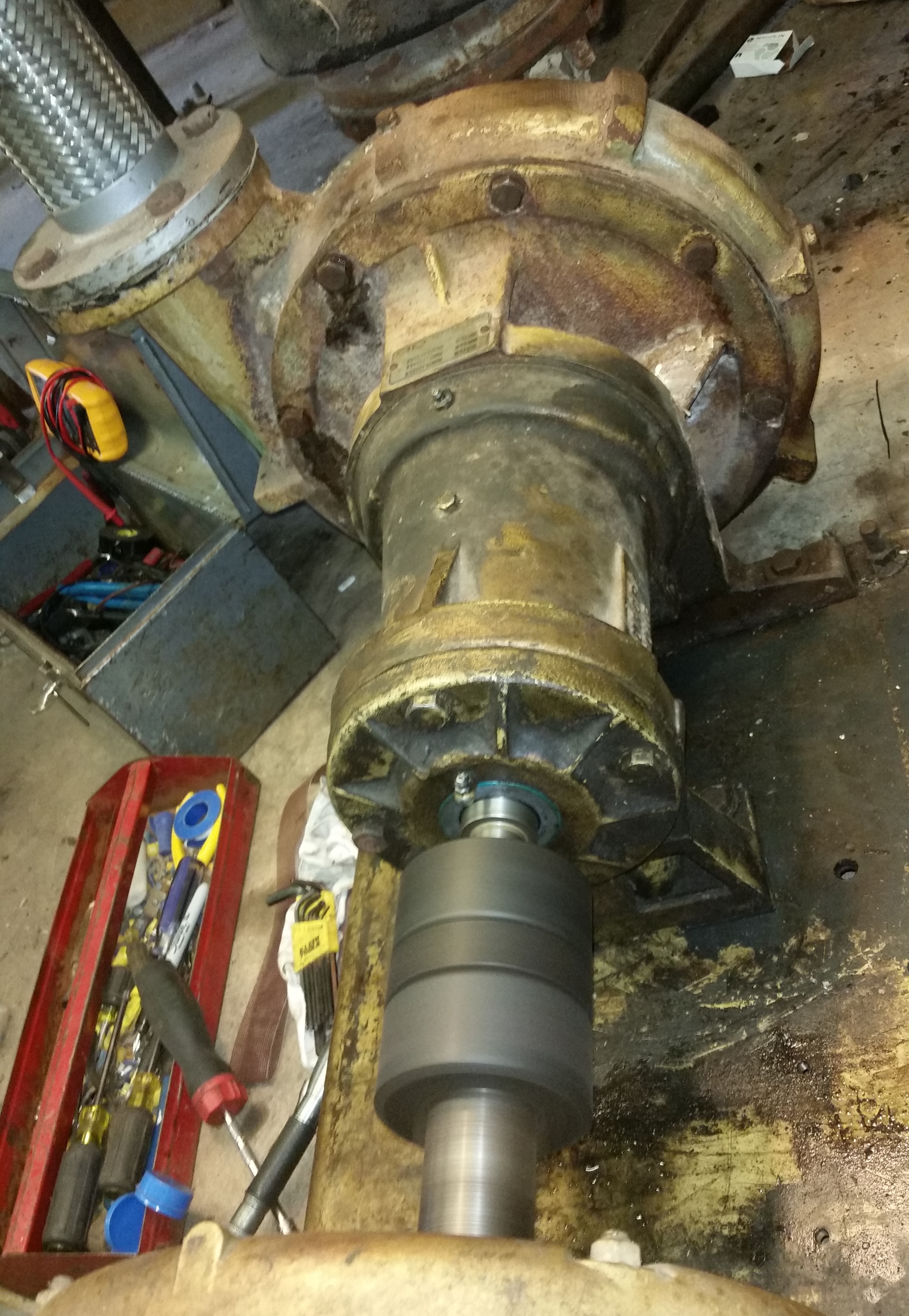 Technician checking chilled water pump status during alarm response